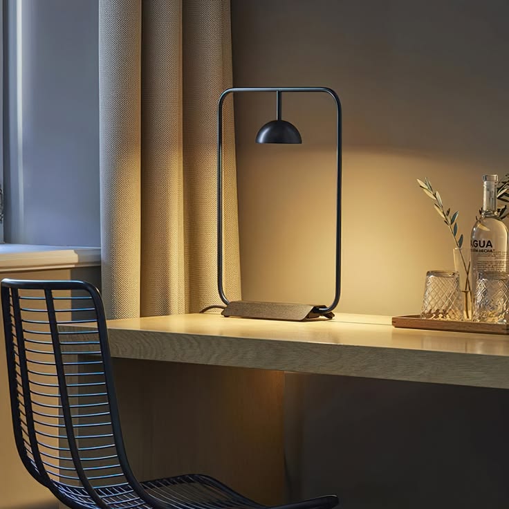 Indoor table with a single lamp casting warm light on stacked notebooks